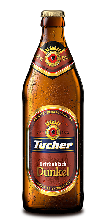 A beer bottle with condensation stands upright, with a label on it.