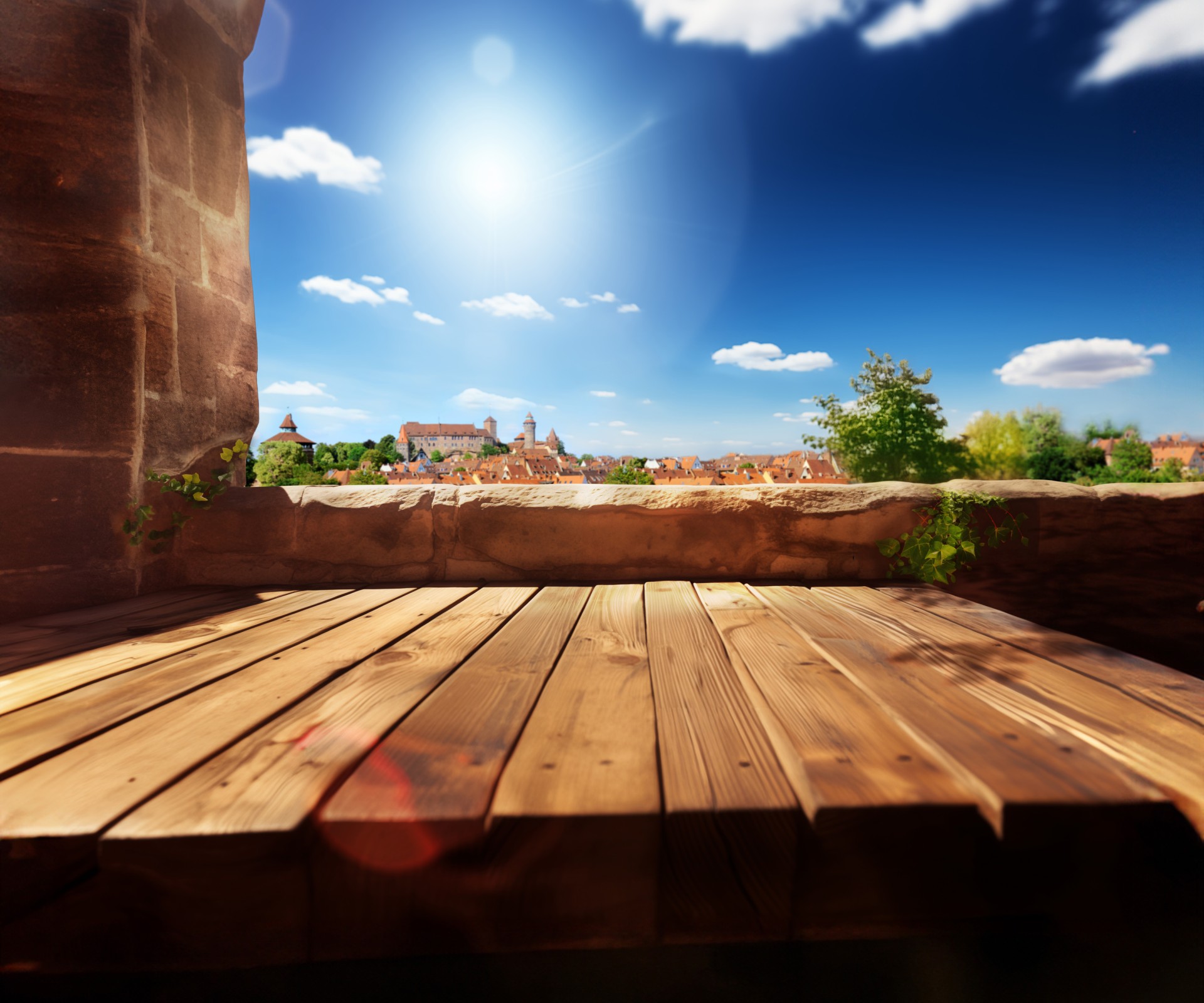 A sunny view of a historic city, seen from a wooden terrace.