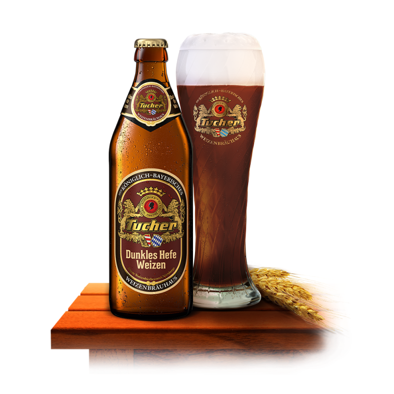 A brown beer bottle stands beside a filled glass on a wooden table.