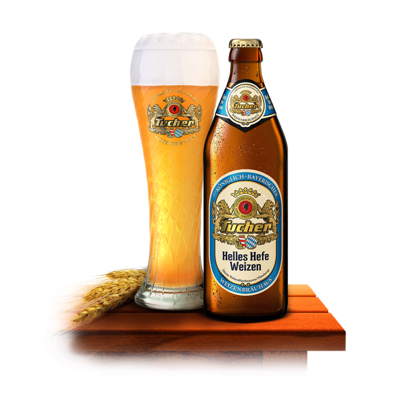 A full beer glass sits beside a sealed bottle on a wooden table.