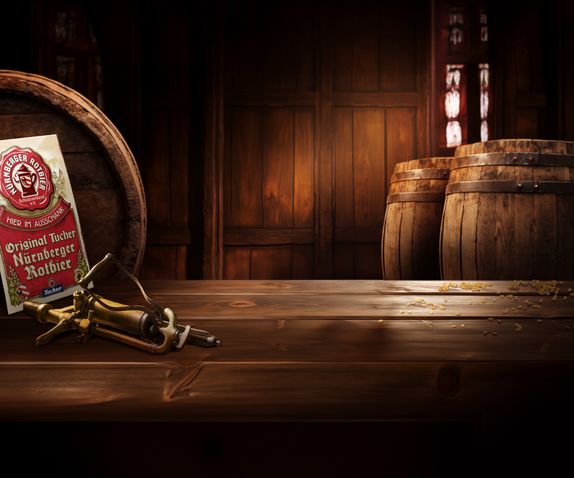 A beer pack and an antique bottle opener lie on a wooden table in front of barrels.